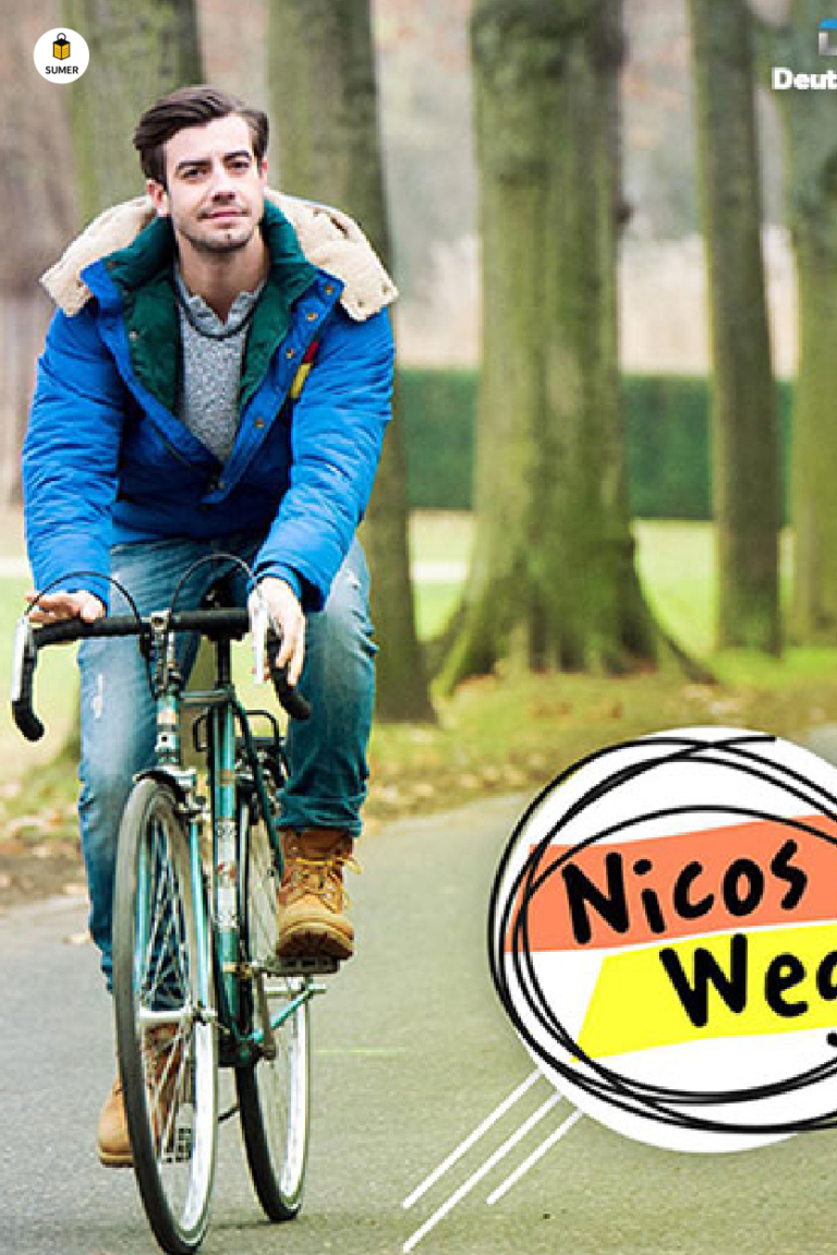 شخصیت اصلی سریال "راه نیکو" (Nicos Weg) در حال دوچرخه‌سواری. این مجموعه ویدیویی از دویچه وله (DW) برای یادگیری آلمانی از سطح A1 تا B1 ساخته شده است.